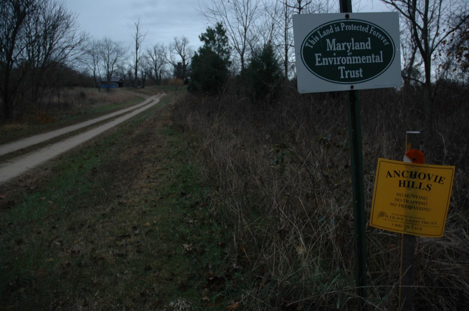Anchovie Hills entrance on Croom Road, signs from the two land trusts that protect it from development.  Photo: Margaret Yocom, 2013.